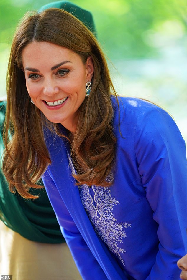 Kate is pictured during a visit to the Margallah Hills on the second day of the royal visit to Pakistan wearing a blue kurta and trousers designed by Pakistani designer Maheen Khan
