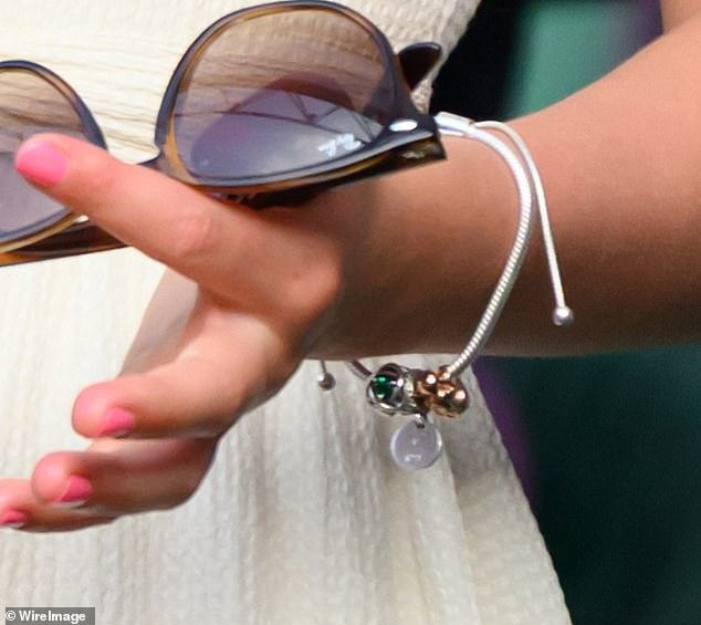 Around her wrist, the young princess wore a charm bracelet with some subtly telling details