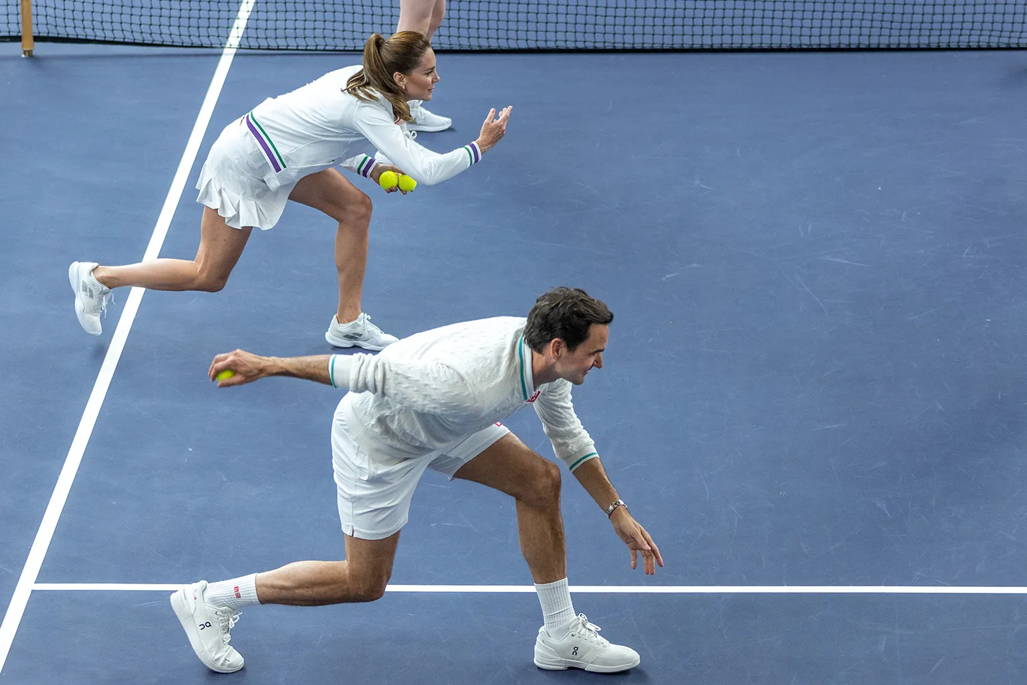 In this handout images released by Kensington Palace on June 24, 2023, Catherine, Princess of Wales and Wimbledon Champion Roger Federer join a ball boy and girl practice in the run up to The Championships 2023. In the AELTC Indoor Tennis Courts at The All England Lawn Tennis Club, Wimbledon, on June 8, 2023 in London, England.