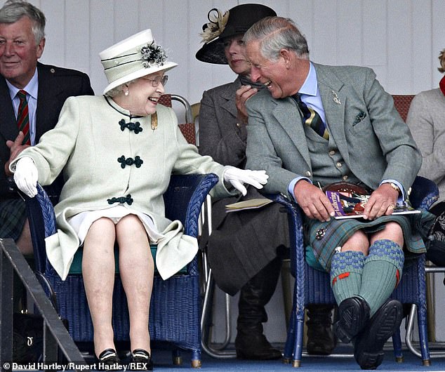 The Queen is pictured sharing a joke with her son, Prince Charles, at Braemar Games in 2010