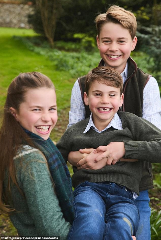 Filled with laughter, the clip shows the future King walking hand-in-hand with his sister and brother, while another adorable moment sees the two eldest royal children lift up the beaming youngest (pictured)