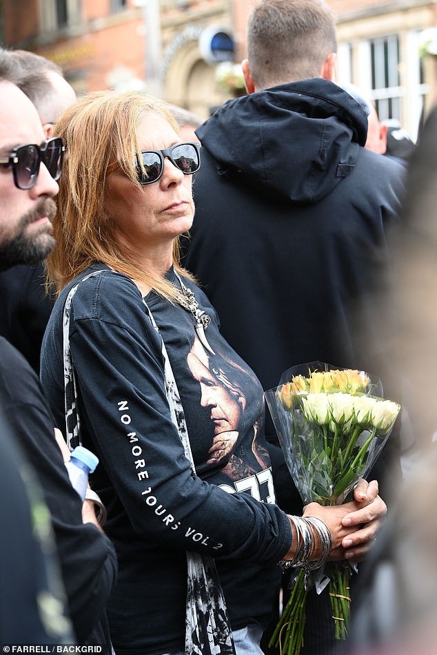 Fans awaiting the arrival of his funeral cortege held floral tributes