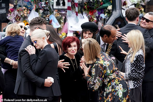 Family members including Sharon (centre) and children Jack and Kelly honoured the rock star