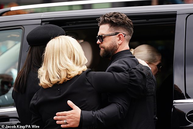 The family enter a car following an outpour of tributes to Ozzy from the city of Birmingham