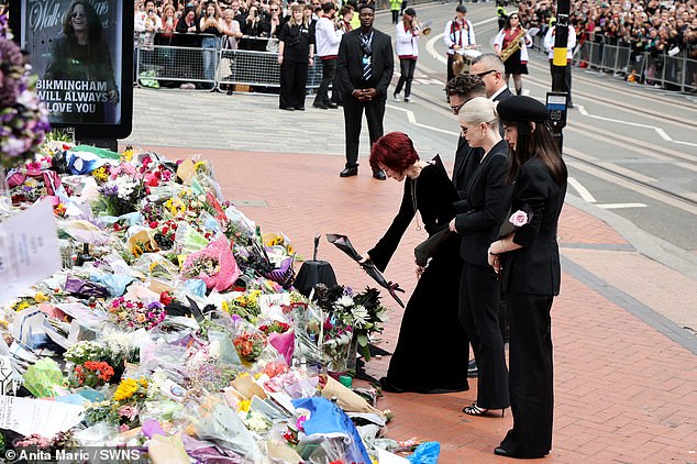Sharon lays down a bouquet of flowers for her husband Ozzy in his hometown of Birmingham