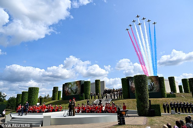 The aerobatic display team of the Royal Air Force, The Red Arrows, fly overhead during the service