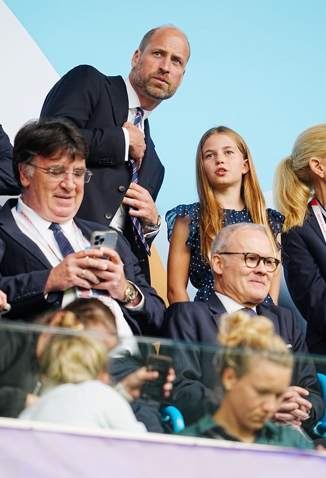 Prince William and Princess Charlotte at a soccer match.