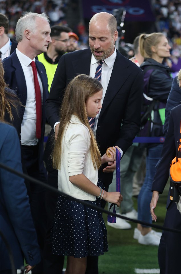 Prince William presenting UEFA Women's Euro 2025 winner's medals to Princess Charlotte.