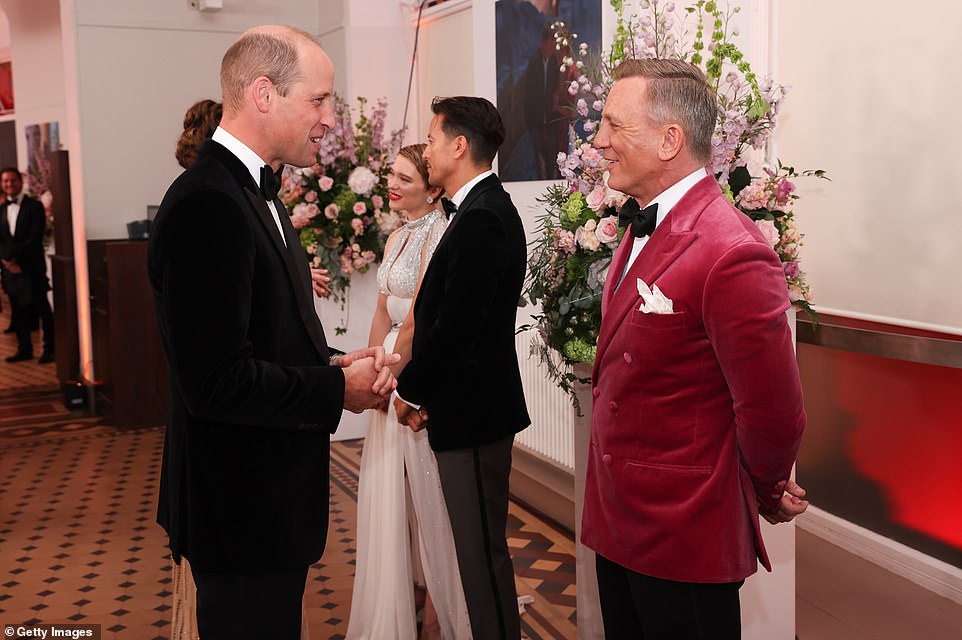 Two dapper gentleman together! Prince William was all smiles as he met the 007 actor at the glittering premiere at the Royal Albert Hall in London