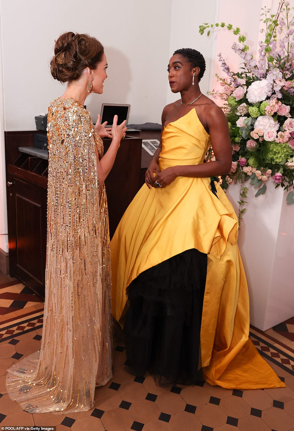 Chatting away: Lashana Lynch and Kate also appeared deep in conversation with the former putting on an animated display