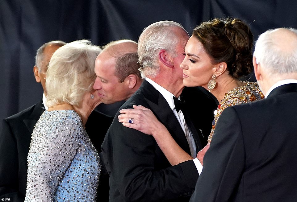 The Duke of Cambridge kisses the Duchess of Cornwall's cheek, while Charles shares a kiss on the cheek with Kate