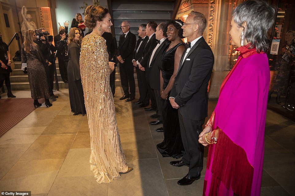 The Duchess of Cambridge laughs as she meets other guests at the No Time To Die world premiere at Royal Albert Hall