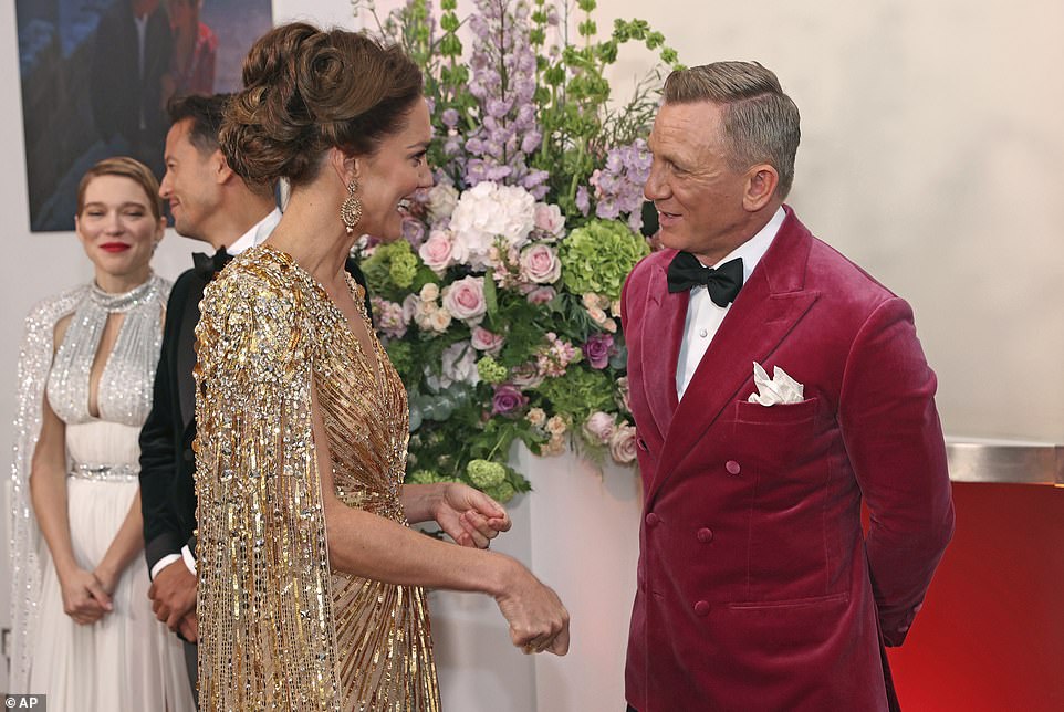 The Duchess of Cambridge dazzled in gold as she met James Bond actor Daniel Craig on the red carpet ahead of the film premiere yesterday evening