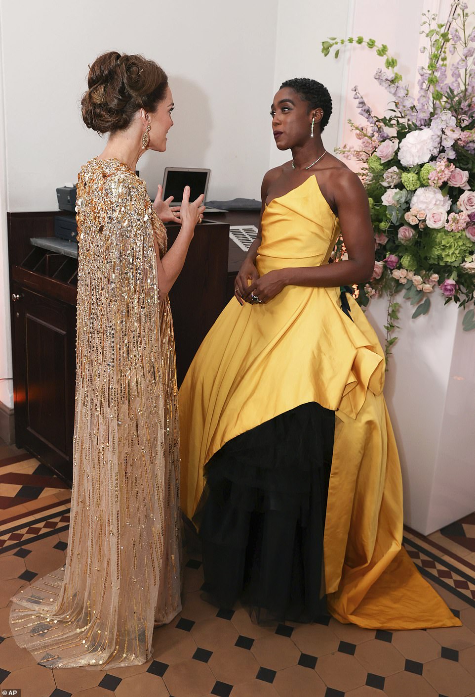 Both Kate and actress Lashana Lynch looked resplendent as they chatted ahead of the long-awaited James Bond film at the Royal Albert Hall yesterday night
