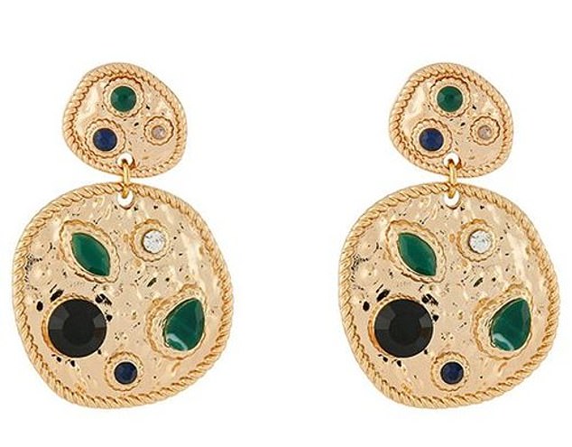 The emerald gemstones of her £14 earrings matched the shade of her frock, enhancing her polished aesthetic