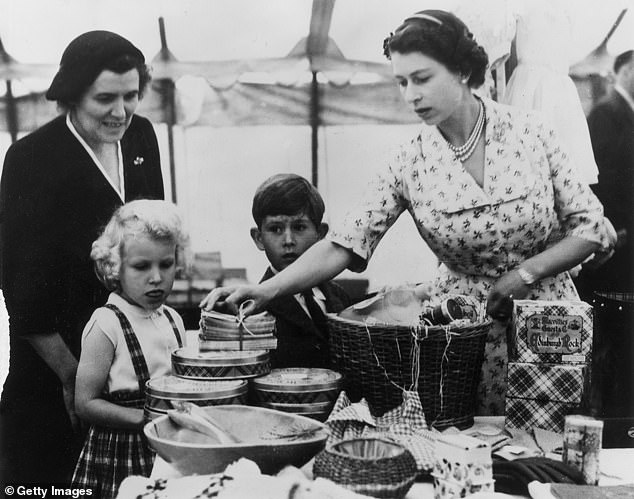 The late Queen with a young King Charles and Princess Anne. Gyles Brandreth claims that Elizabeth's love of washing up started at a young age