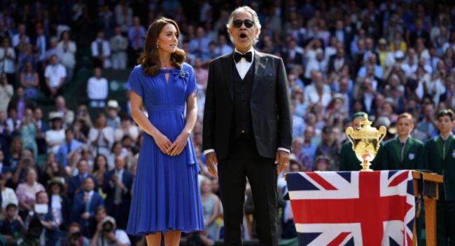 Wimbledon had never seen silence like this. No announcement. No spotlight. Just the Princess of Wales stepping onto Centre Court beside Andrea Bocelli, as 15,000 spectators fell still — breath held, hearts paused. And then, with no microphone, Catherine began to sing: “God Save the King.” Her voice — delicate yet steady — intertwined with Bocelli’s soaring tenor, lifting through the summer air like a prayer wrapped in tradition. It wasn’t just a performance. It was a moment. Some called it a symbol of unity. Others, a quiet message in uncertain times. But one thing is certain: Catherine’s voice didn’t just echo across Centre Court… it echoed across a nation. 👇👇 WATCH THE MOMENT THAT MADE HISTORY