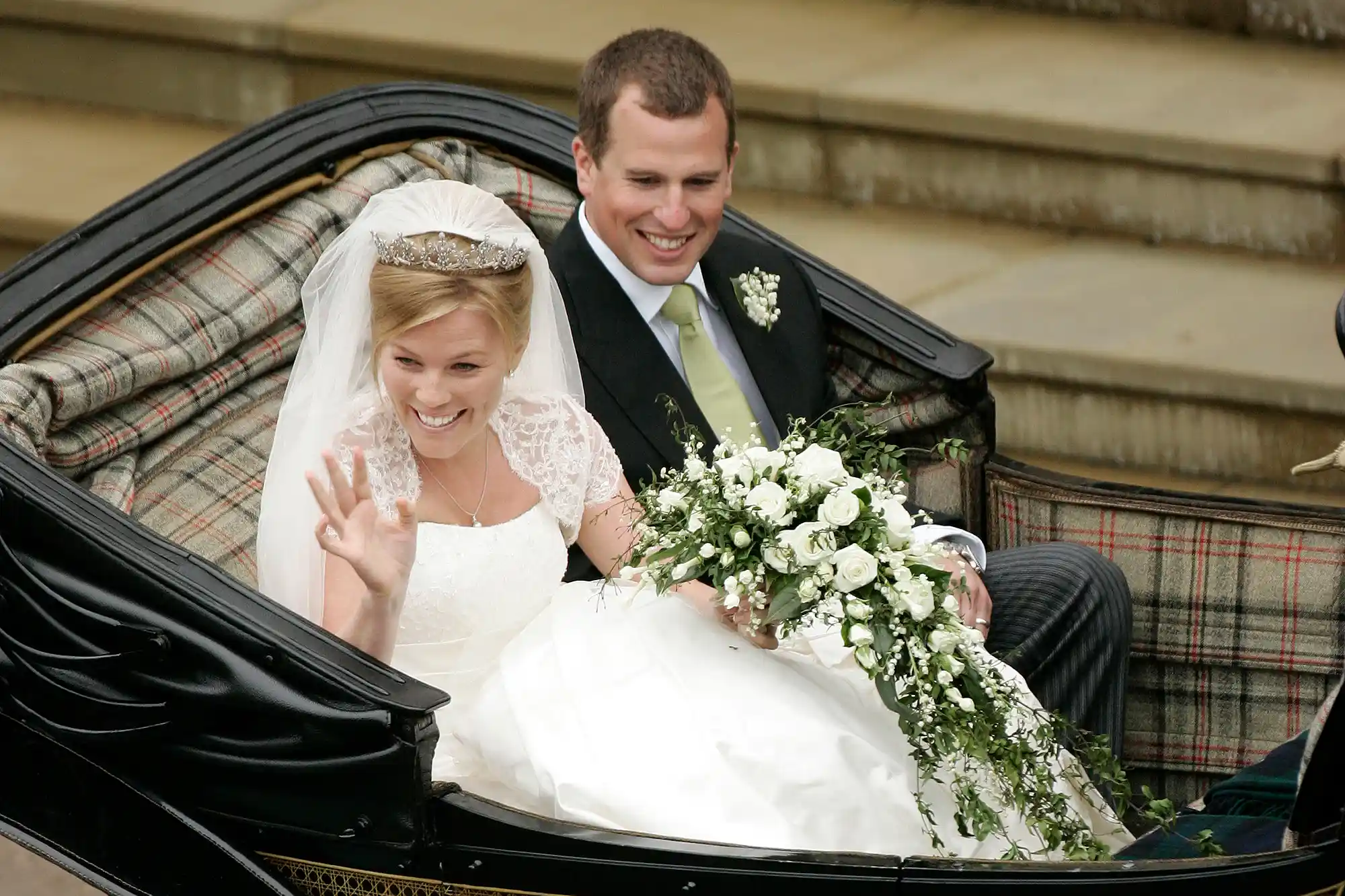 WINDSOR, UNITED KINGDOM - MAY 17: Peter Phillips and Autumn Kelly leave in an open carriage following their wedding at St. George's Chapel on May 17, 2008 in Windsor, England.