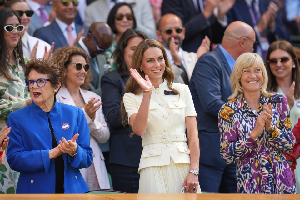 Kate, Princess of Wales, waves from the Royal Box at Wimbledon with Billie Jean King.