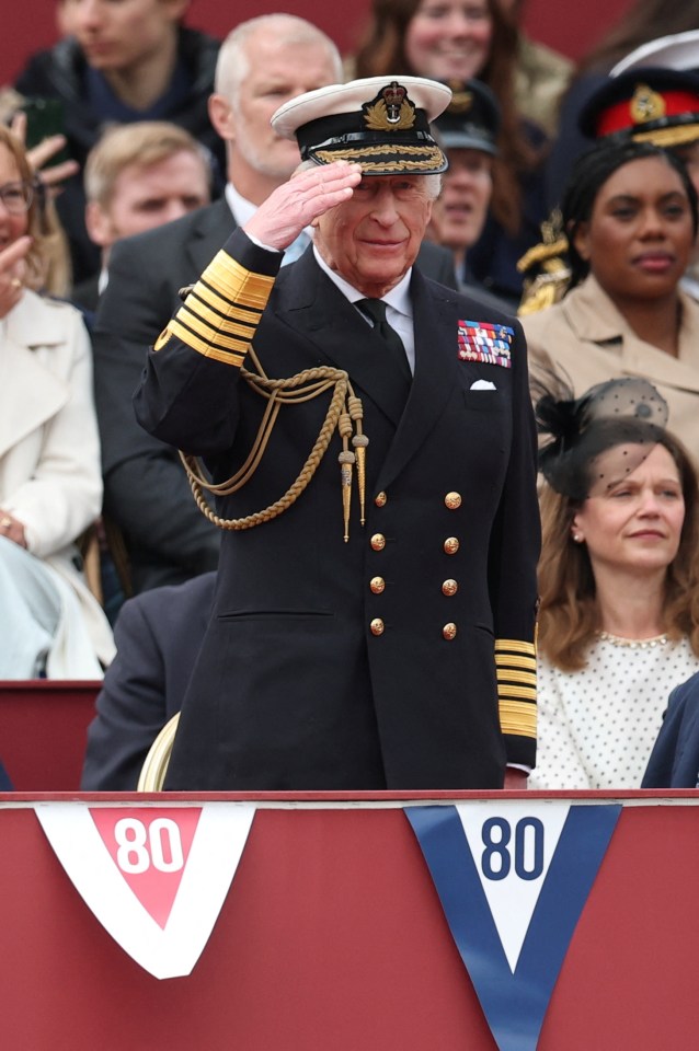 King Charles III saluting at a VE Day parade.
