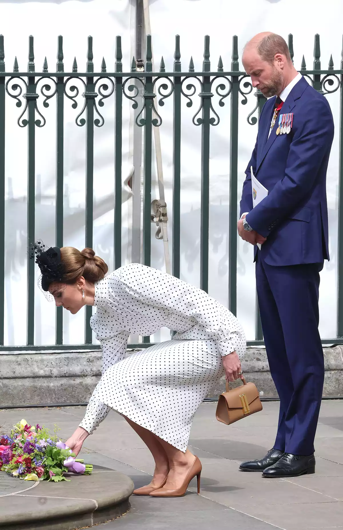 Catherine, Princess of Wales lays flowers on the Innocent Victims’ Memorial with Prince William, Prince of Wales as they depart the Thanksgiving Service to mark the 80th anniversary of VE Day