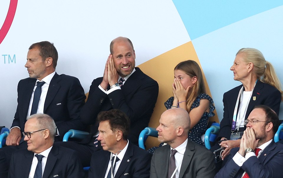 Prince William and Princess Charlotte watching a soccer match.