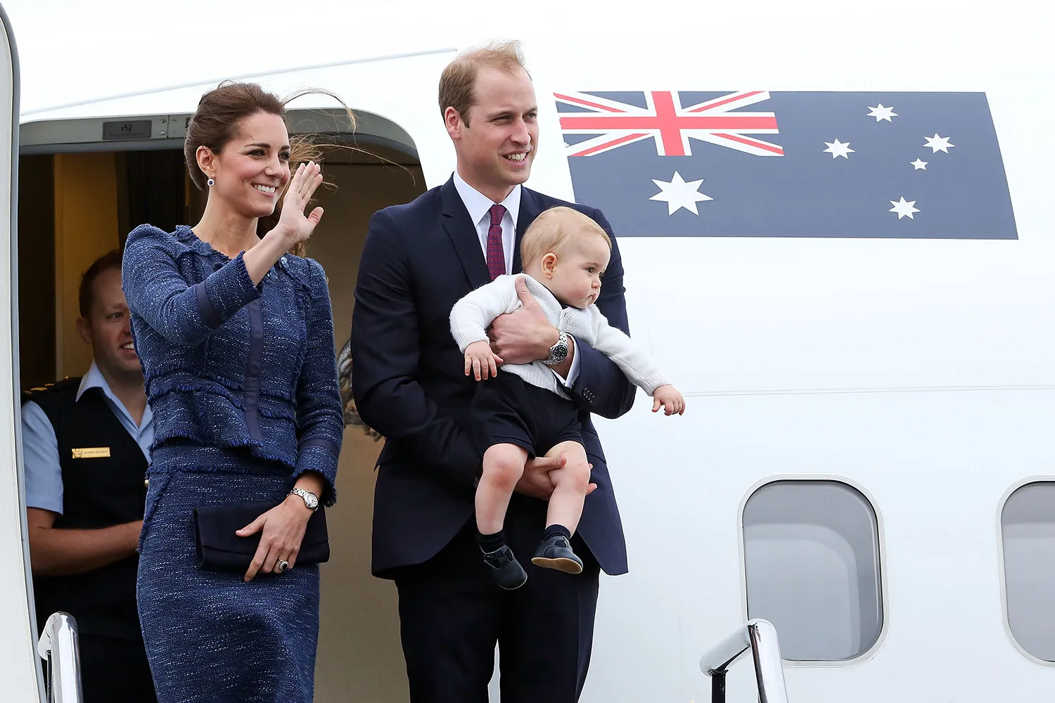 Catherine, Duchess of Cambridge, Prince William, Duke of Cambridge and Prince George of Cambridge wave to the crowd before boarding a Royal Australian Air Force plane their flight to Australia at Wellington Airport's military terminal April 16, 2014 in Wellington, New Zealand