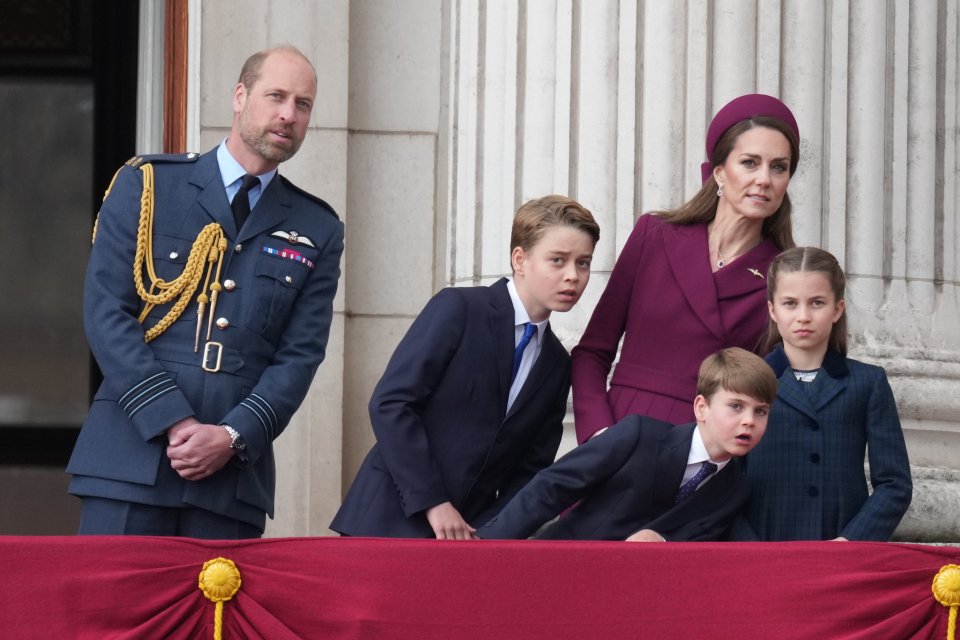 Prince William, Kate Middleton, and their three children on a balcony.
