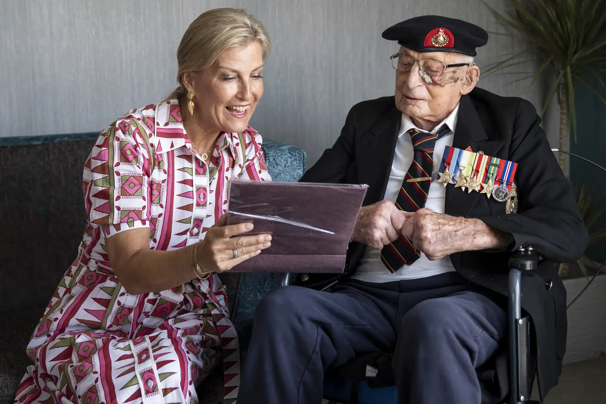Sophie, Duchess of Edinburgh, patron of the Java Far East Prisoner of War Club 1942, views photographs with 105-year-old Royal Marines veteran James 'Jim' Wren, at the Old Sarum Manor Care Home in Salisbury, ahead of the 80th anniversary of VJ Day on August 12, 2025 in Salisbury, England.