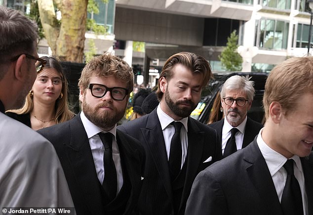 (centre left to right) Columbus Taylor and Cassius Taylor arrive for the funeral service today