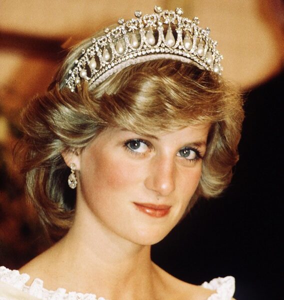 “You were an angel in the shape of my mum…” The words barely left Prince William’s lips before his voice cracked — a soft, trembling whisper that carried across the candlelit Sunken Garden of Kensington Palace. Beside him, Prince Harry lowered his head, eyes glistening, as the brothers stood shoulder to shoulder on what would have been Princess Diana’s 64th birthday. There were no reporters, no speeches, no royal protocol. Just lanterns. Just family. Just two sons honoring the woman who changed the world. Then, in a moment no one saw coming, William nodded — and a piano began to play. Supermarket Flowers. But not the version the world knows. This one had been rewritten — quiet, aching lines shaped from their own memories: “You taught us grace long before we knew its name… You held our hands through storms the world never saw…” Their voices rose gently into the night, blending in a way they hadn’t in years. Behind them, soft projections flickered to life: Diana cradling children in hospitals, laughing with families in need, stepping fearlessly through landmine fields, her smile bright enough to warm a world she constantly tried to heal.