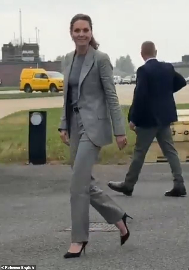 Kate opted for a sleek grey trouser suit and a smart pair of black heels