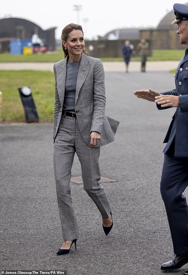 She appeared to be wearing a pair of diamond and sapphire earrings that once belonged to Princess Diana and pinned a gold winged RAF brooch to her blazer