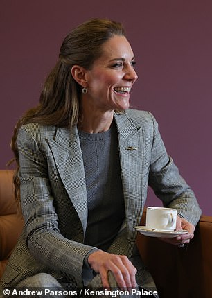 Kate beamed as she was given a cup of tea