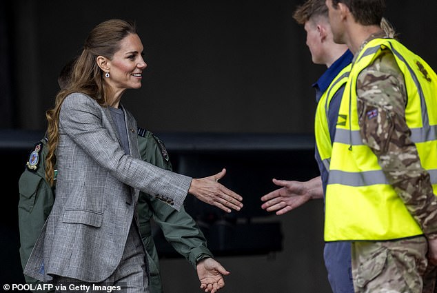 Upon arrival, she shook hands with those who work at the RAF base