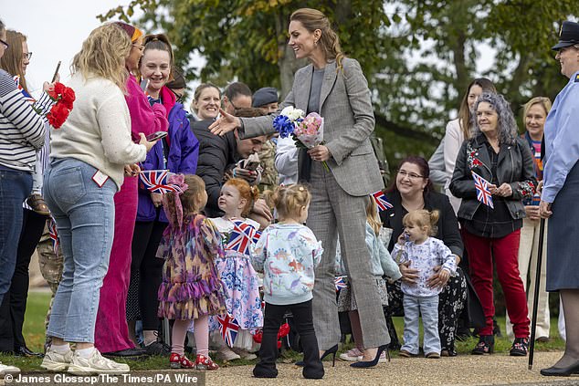 Kate admired several of the little girls' princess dresses and apologised that she wasn't wearing one