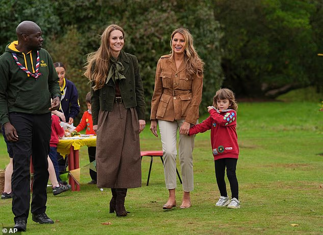 One little girl held Melania's hand as they strolled in Frogmore Gardens