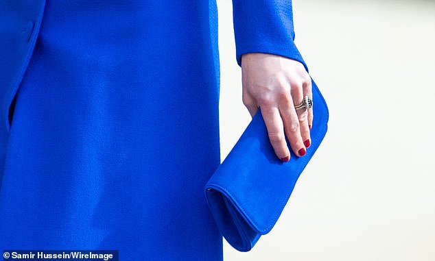 The mother-of-three had her nails painted dark red - a far cry from the neutral or clear shades she typically wears for public appearances with the Royal Family