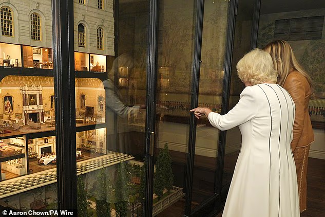 Camilla and Melania chatted with a staff member at the Royal Library at Windsor Castle on Thursday