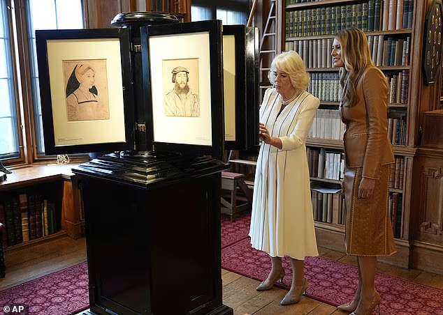 Melania Trump and Queen Camilla look at a collection at the Royal Library at Windsor Castle