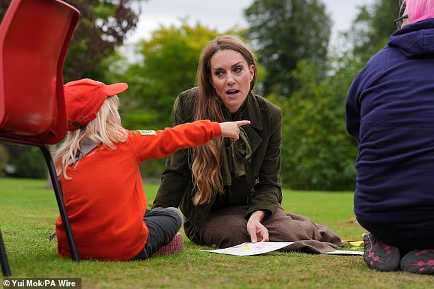 Kate responded to one of the Squirrel Scouts as she tried to show her something in the garden