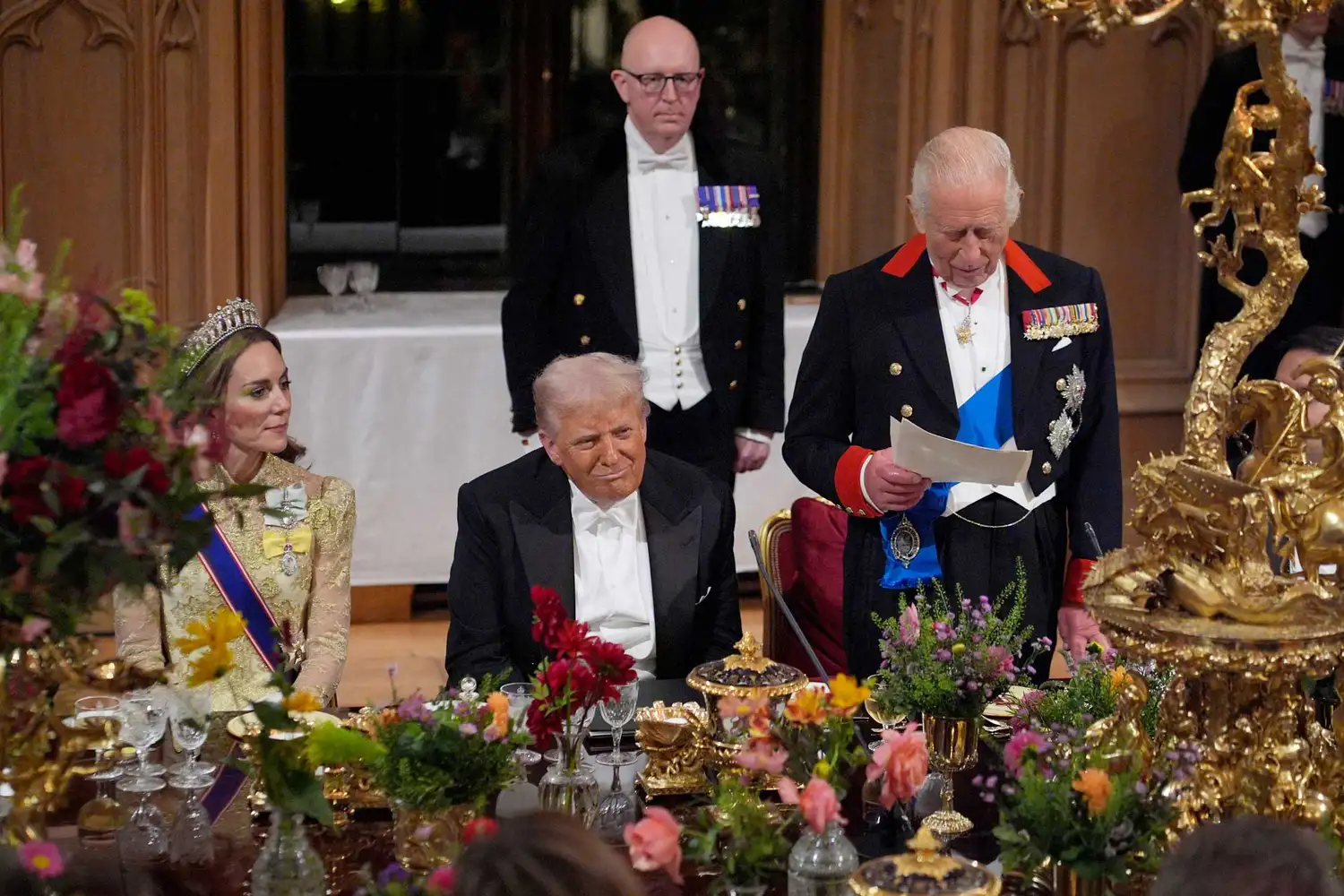 US President Donald Trump reacts as Britain's King Charles III delivers a speech during a State Banquet at Windsor Castle, in Windsor, on September 17, 2025,