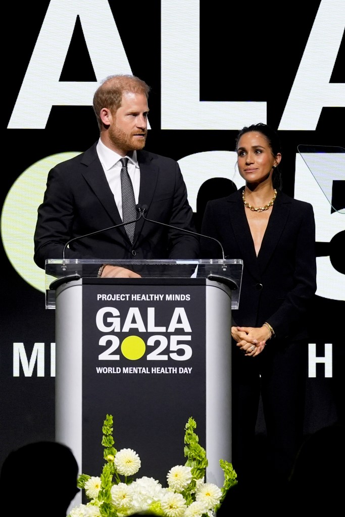 Prince Harry and Meghan Markle speak onstage after accepting the Humanitarian of the Year award at the Project Healthy Minds Gala in New York City on Oct. 9, 2025.
