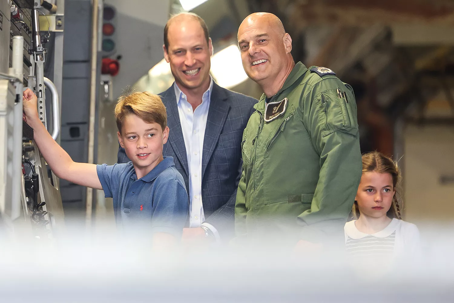 Prince George of Wales raises the ramp on the C17 plane during the visit to the Air Tattoo at RAF Fairford with Prince William, Prince of Wales and Princess Charlotte of Wales on July 14, 2023 in Fairford, England