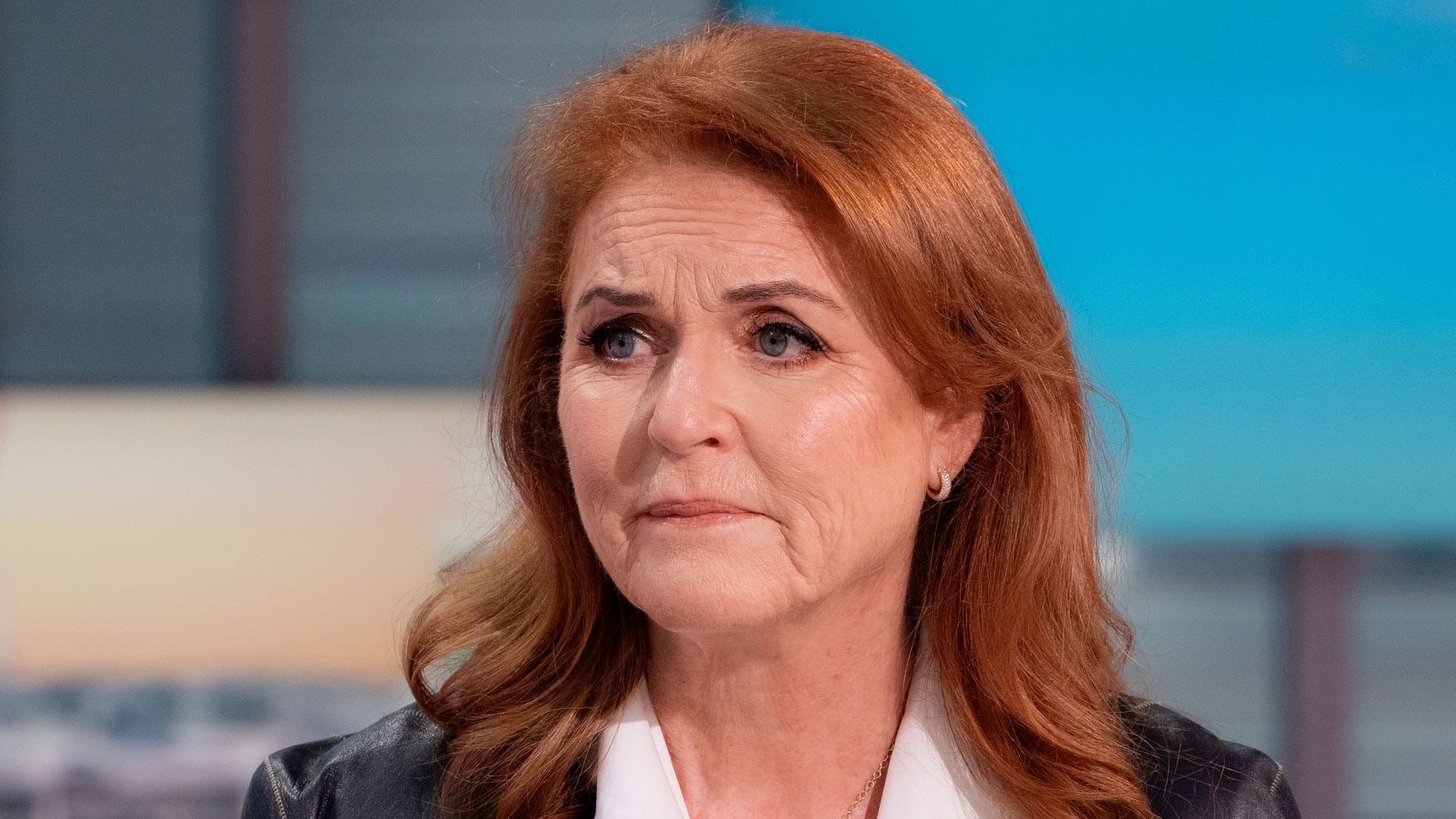 Sarah Ferguson looking sad in a white shirt and leather jacket