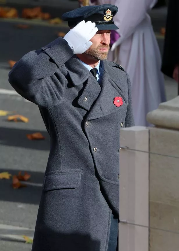 William salutes after laying  his wreath