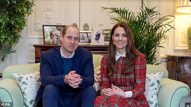 The Prince and Princess of Wales are pictured in 2021 from one of their living rooms in their Kensington Palace apartment. Their home featured many family photos