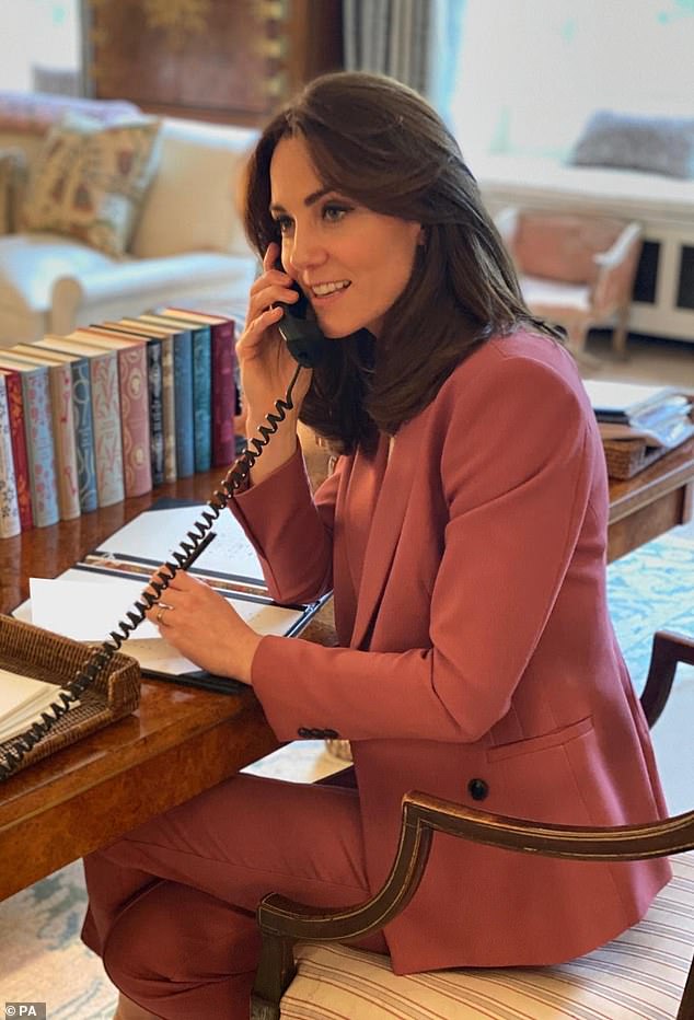 The Princess of Wales is pictured in 2020 in her stylishly decorated office in Kensington Palace - complete with piles of classic books in the background