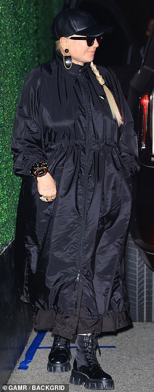 Her ensemble included a boxy anorak that fell to the ankle, as well as a baseball cap, a pair of shades and a set of low-top leather boots