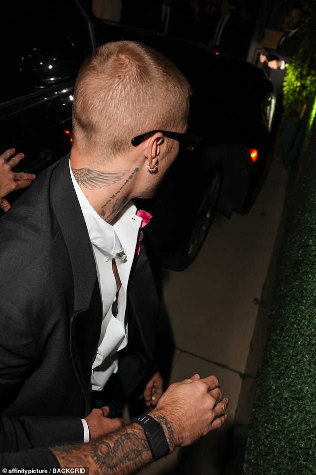 He left a few top buttons undone and went without a tie